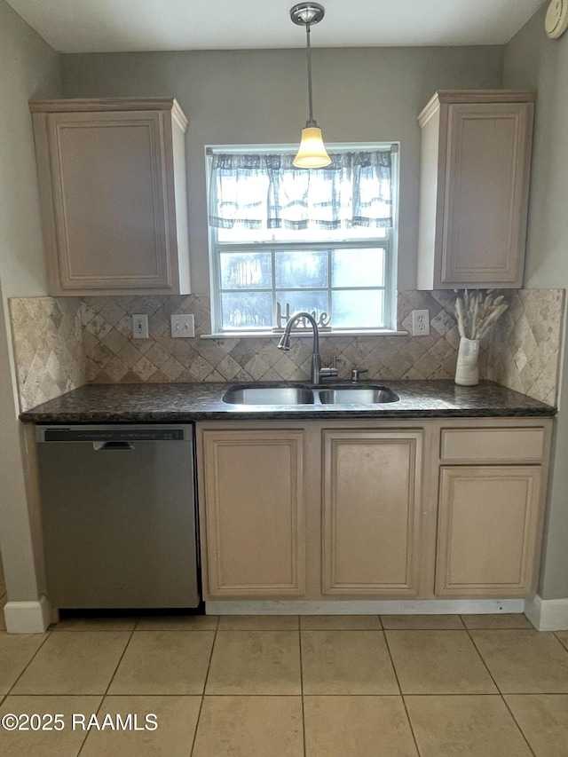 103 E Weeks Dr, Youngsville, LA 70592 - kitchen with dishwasher, a sink, dark countertops, decorative backsplash, and light tile patterned floors