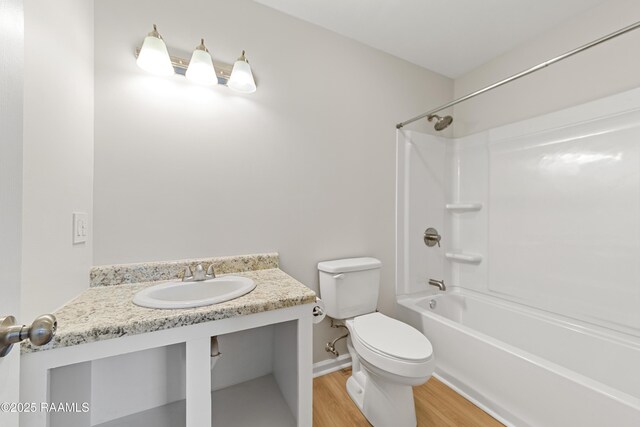 315 Kelso Dr, Carencro, LA 70520 - bathroom featuring toilet, wood finished floors, bathtub / shower combination, and vanity