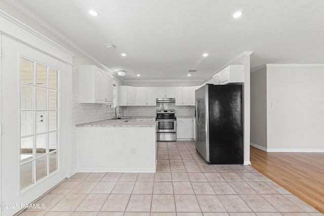315 Kelso Dr, Carencro, LA 70520 - kitchen featuring appliances with stainless steel finishes, crown molding, a sink, under cabinet range hood, and white cabinetry