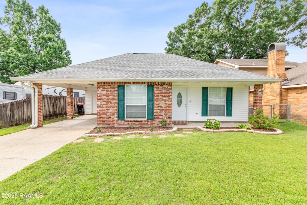 315 Kelso Dr, Carencro, LA 70520 - ranch-style house with roof with shingles, driveway, an attached carport, and brick siding