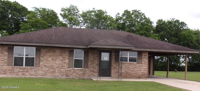 12017 Judge Doucet Rd, Abbeville, LA 70510 - ranch-style house with roof with shingles, a front lawn, driveway, and brick siding