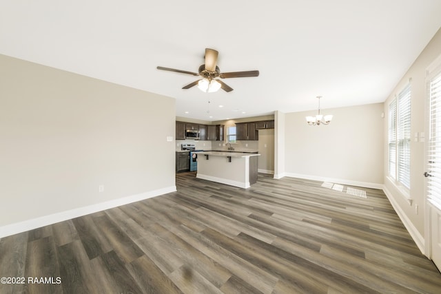 119 Sandstone Ave, Scott, LA 70583 - unfurnished living room featuring a chandelier, ceiling fan, wood finished floors, baseboards, and recessed lighting
