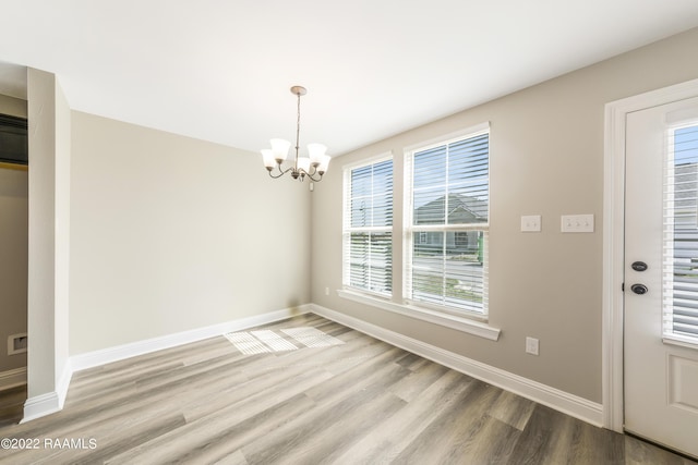 119 Sandstone Ave, Scott, LA 70583 - unfurnished dining area featuring a chandelier, wood finished floors, and baseboards