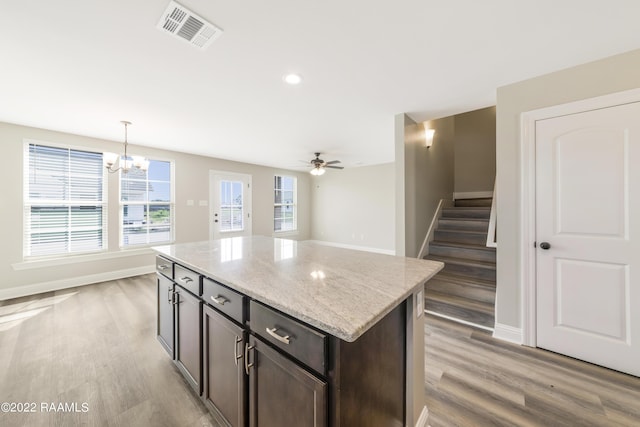 119 Sandstone Ave, Scott, LA 70583 - kitchen featuring light wood-type flooring, a kitchen island, a chandelier, light stone countertops, and recessed lighting