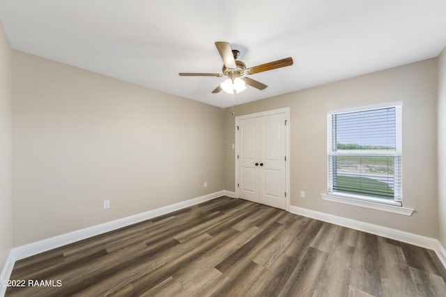 119 Sandstone Ave, Scott, LA 70583 - empty room with dark wood finished floors, a ceiling fan, and baseboards