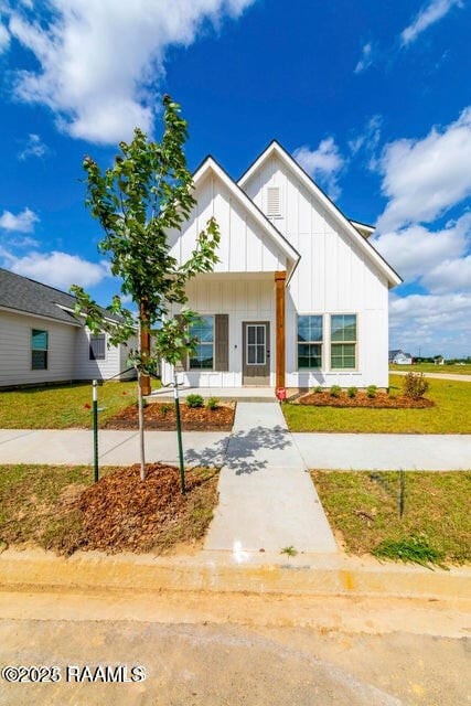 119 Sandstone Ave, Scott, LA 70583 - modern farmhouse with board and batten siding, covered porch, and a front yard