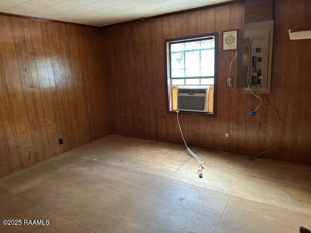 18711 La Highway 35, Abbeville, LA 70510 - empty room featuring electric panel, wooden walls, and cooling unit