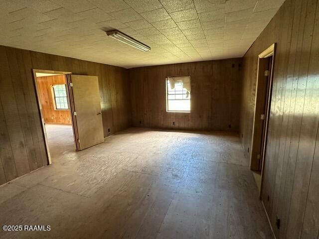 18711 La Highway 35, Abbeville, LA 70510 - spare room with plenty of natural light, wood walls, and light wood finished floors