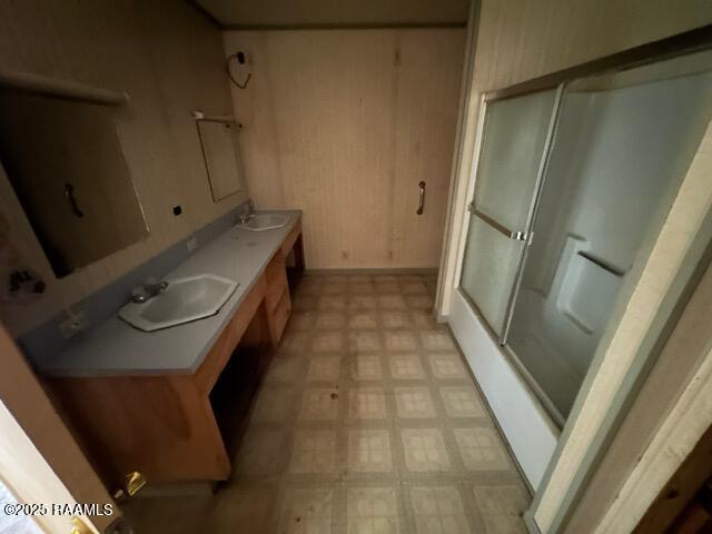 18711 La Highway 35, Abbeville, LA 70510 - full bath with tile patterned floors, a shower with shower door, wood walls, and double vanity