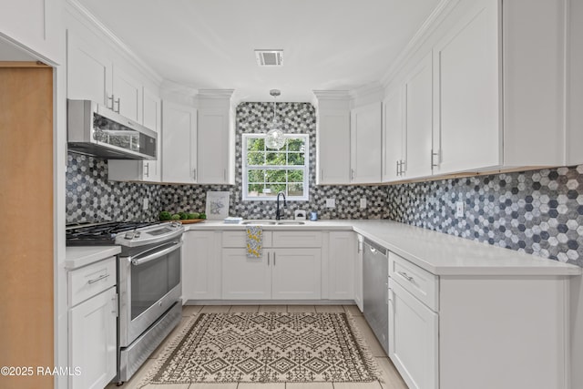 110 Memory Ln, Lafayette, LA 70506 - kitchen with stainless steel appliances, light countertops, white cabinetry, backsplash, and a sink