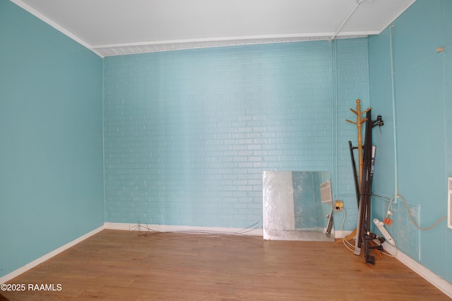 2116 George Dr, Opelousas, LA 70570 - unfurnished room featuring brick wall, wood finished floors, and baseboards