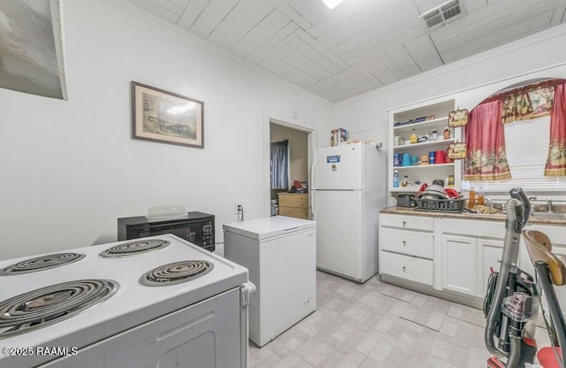1110 Louisiana Ave, Lafayette, LA 70501 - kitchen with white appliances, white cabinetry, light countertops, and open shelves
