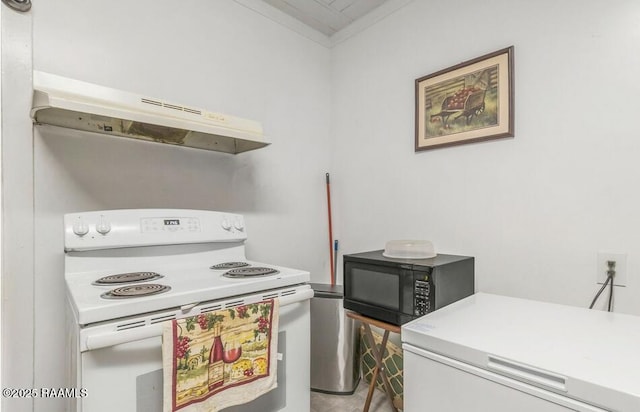 1110 Louisiana Ave, Lafayette, LA 70501 - kitchen with electric range, black microwave, under cabinet range hood, refrigerator, and light countertops