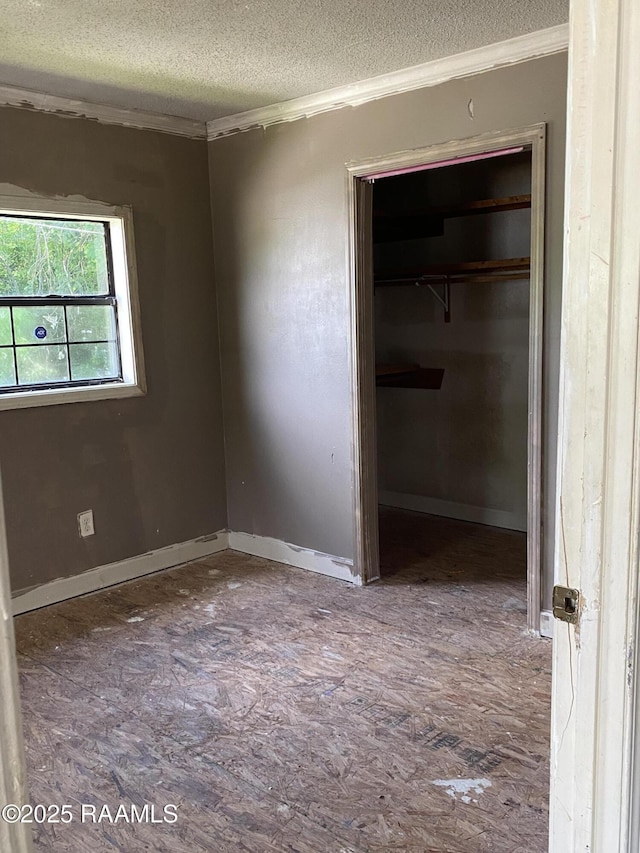 913 Plum St, Lafayette, LA 70501 - unfurnished bedroom with crown molding, a textured ceiling, and a closet