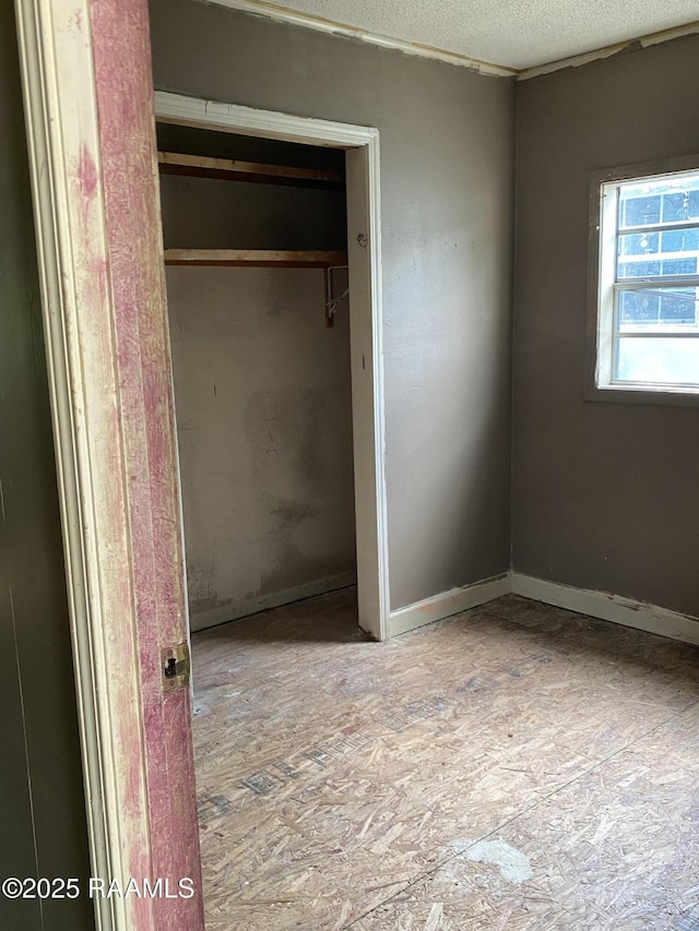 913 Plum St, Lafayette, LA 70501 - unfurnished bedroom with a textured ceiling and a closet