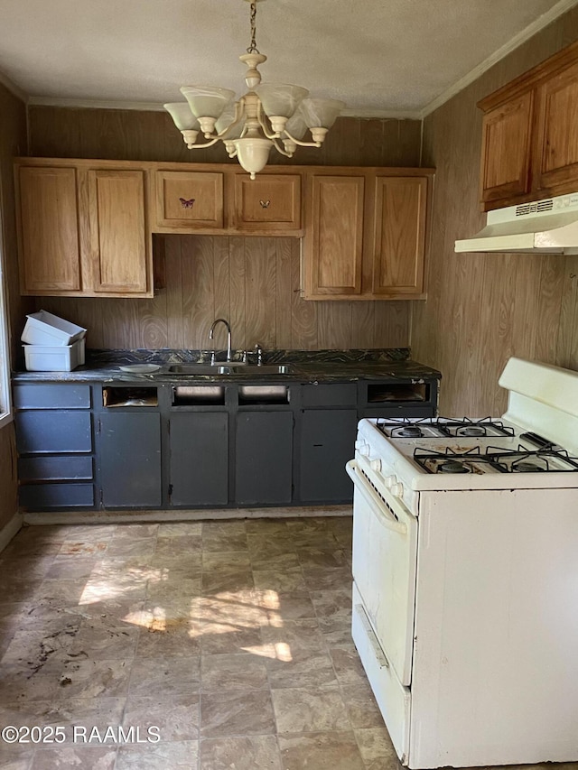 913 Plum St, Lafayette, LA 70501 - kitchen with white range with gas stovetop, under cabinet range hood, a sink, a chandelier, and crown molding