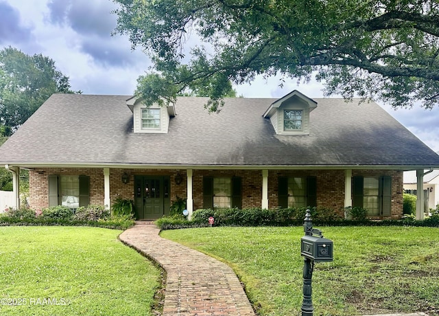 404 Old Settlement Rd, Lafayette, LA 70508 - cape cod house with brick siding, a front lawn, and a shingled roof