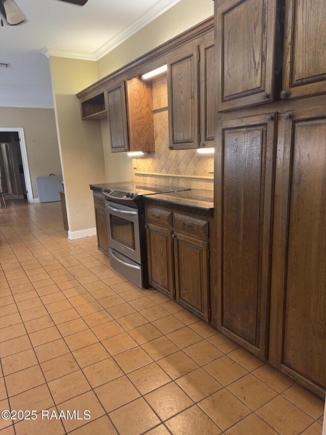 404 Old Settlement Rd, Lafayette, LA 70508 - kitchen featuring electric stove, light tile patterned flooring, ornamental molding, tasteful backsplash, and dark countertops