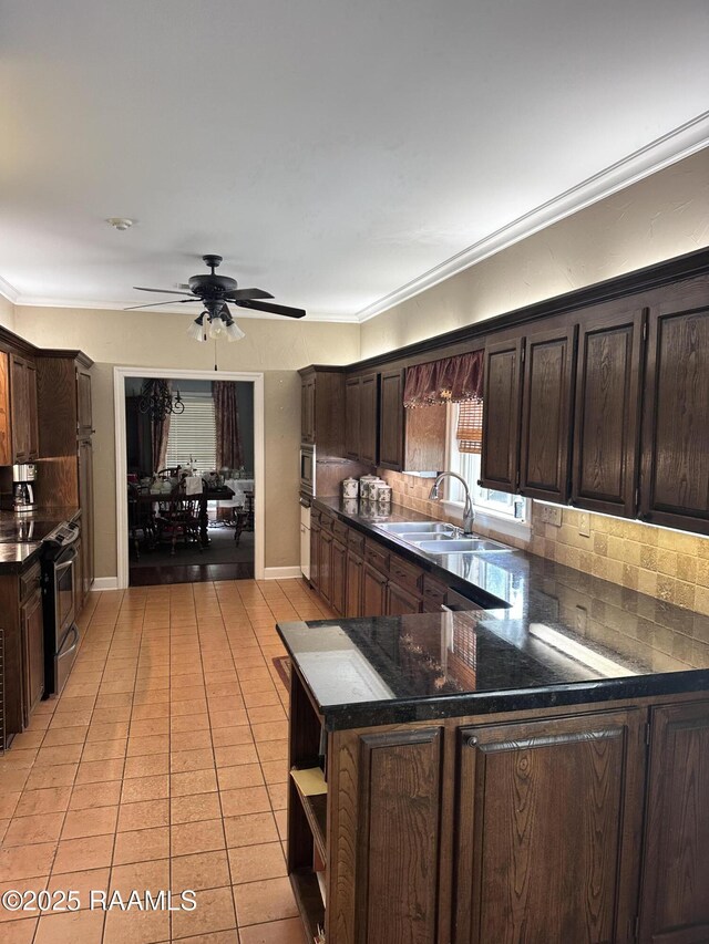 404 Old Settlement Rd, Lafayette, LA 70508 - kitchen featuring a sink, electric stove, a ceiling fan, light tile patterned floors, and dark brown cabinetry