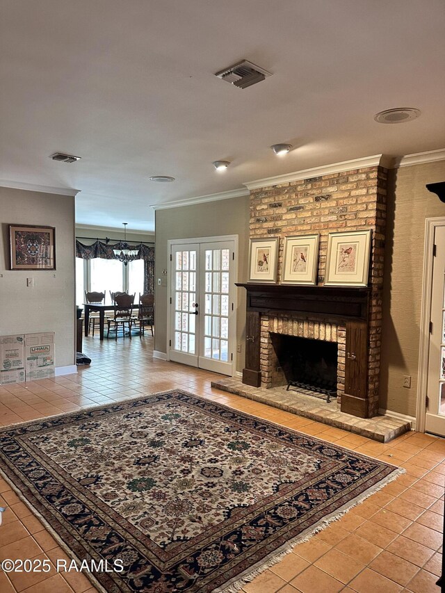 404 Old Settlement Rd, Lafayette, LA 70508 - living area featuring light tile patterned floors, crown molding, a fireplace, french doors, and baseboards