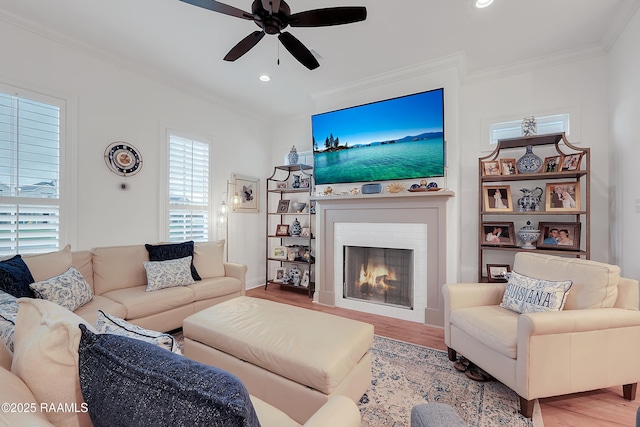 337 Bozeman Trl, Scott, LA 70583 - living room with ceiling fan, wood finished floors, crown molding, a warm lit fireplace, and recessed lighting
