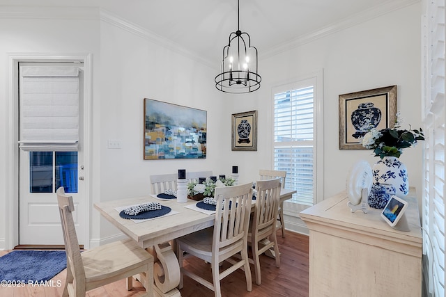 337 Bozeman Trl, Scott, LA 70583 - dining area featuring wood finished floors, a chandelier, and crown molding
