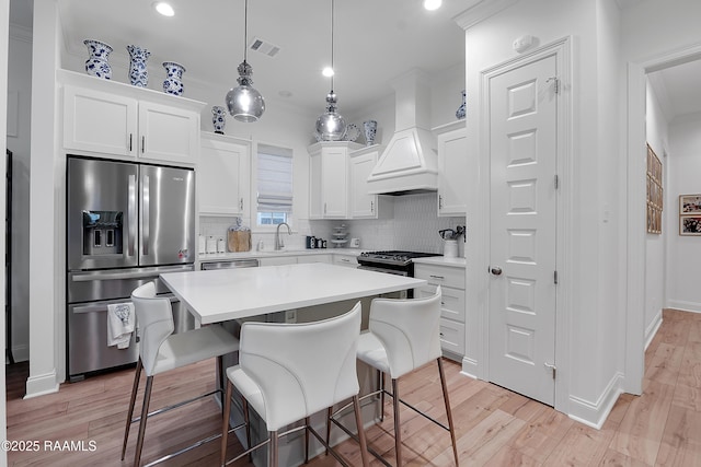 337 Bozeman Trl, Scott, LA 70583 - kitchen with stainless steel appliances, decorative backsplash, light wood finished floors, and recessed lighting
