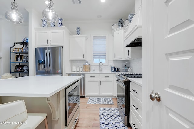 337 Bozeman Trl, Scott, LA 70583 - kitchen with stainless steel appliances, light countertops, tasteful backsplash, white cabinetry, and light wood finished floors