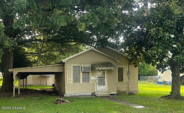 805 S Mcgown St, Rayne, LA 70578 - bungalow-style home featuring a front lawn, entry steps, and an attached carport
