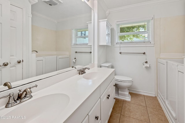 4119 Pleasant Dr, Lake Charles, LA 70605 - bathroom featuring toilet, double vanity, crown molding, tile patterned flooring, and baseboards