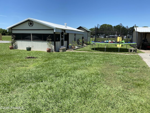 119 Opus Ln, Lafayette, LA 70506 - view of grassy yard featuring a trampoline