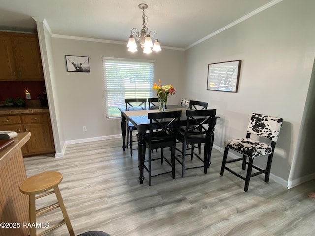 119 Opus Ln, Lafayette, LA 70506 - dining room featuring light wood-style floors, baseboards, ornamental molding, a chandelier, and lofted ceiling