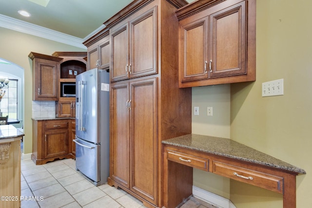 605 Terrell Ct, New Iberia, LA 70563 - kitchen with stainless steel appliances, crown molding, stone counters, light tile patterned floors, and tasteful backsplash