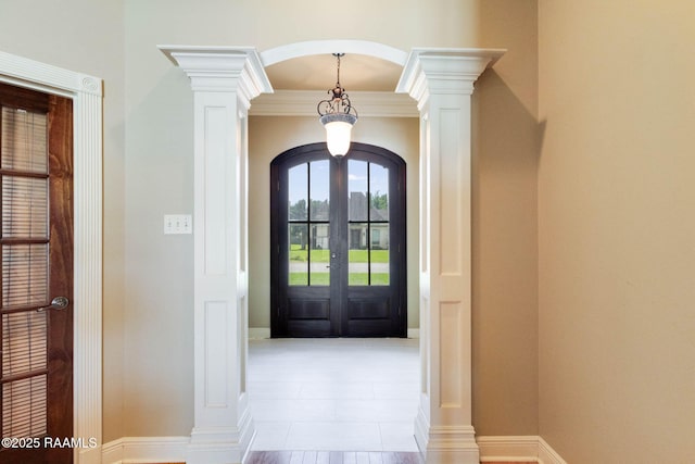 605 Terrell Ct, New Iberia, LA 70563 - tiled entrance foyer with arched walkways, french doors, decorative columns, and baseboards