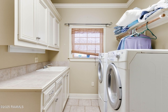 605 Terrell Ct, New Iberia, LA 70563 - laundry area with cabinet space, washer and clothes dryer, ornamental molding, light tile patterned floors, and baseboards