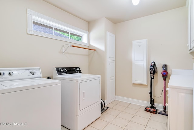 2424 Vista Dr, Opelousas, LA 70570 - laundry area featuring washing machine and clothes dryer, cabinet space, baseboards, and light tile patterned floors