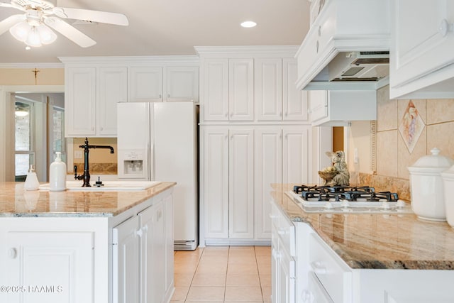 2424 Vista Dr, Opelousas, LA 70570 - kitchen featuring premium range hood, white appliances, white cabinetry, tasteful backsplash, and recessed lighting