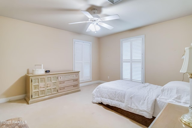 2424 Vista Dr, Opelousas, LA 70570 - bedroom featuring baseboards, light carpet, and a ceiling fan
