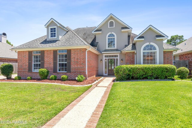 202 Kincaid Ct, Lafayette, LA 70508 - traditional home with a shingled roof, brick siding, and stucco siding