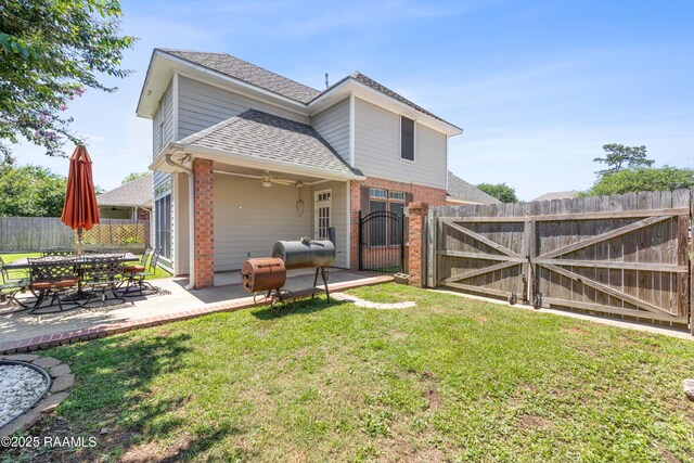 202 Kincaid Ct, Lafayette, LA 70508 - back of house with roof with shingles, brick siding, a gate, a patio, and a ceiling fan