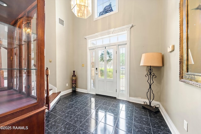 202 Kincaid Ct, Lafayette, LA 70508 - foyer entrance featuring baseboards, a chandelier, a towering ceiling, and granite floors