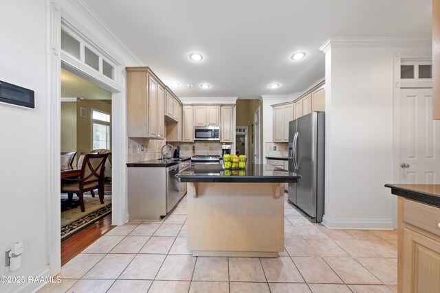 202 Kincaid Ct, Lafayette, LA 70508 - kitchen featuring appliances with stainless steel finishes, crown molding, a sink, decorative backsplash, and dark countertops
