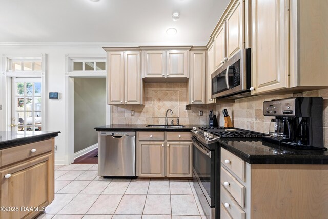 202 Kincaid Ct, Lafayette, LA 70508 - kitchen featuring appliances with stainless steel finishes, a sink, light tile patterned floors, tasteful backsplash, and ornamental molding