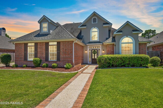 202 Kincaid Ct, Lafayette, LA 70508 - traditional home with roof with shingles, brick siding, and stucco siding