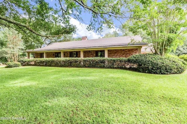 138 Cypress Dr, Opelousas, LA 70570 - ranch-style home featuring a front yard, a chimney, and brick siding