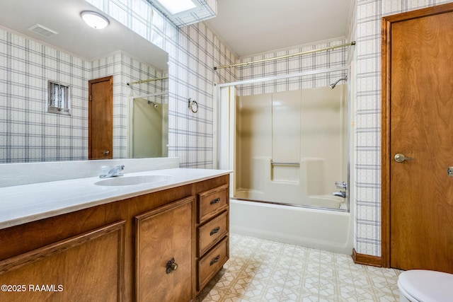 138 Cypress Dr, Opelousas, LA 70570 - full bathroom with wallpapered walls, toilet, vanity, bathtub / shower combination, and tile patterned floors