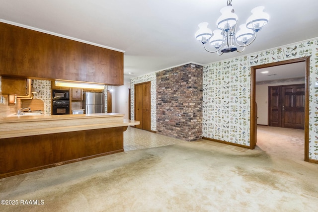 138 Cypress Dr, Opelousas, LA 70570 - kitchen featuring freestanding refrigerator, black microwave, a chandelier, carpet floors, and wallpapered walls