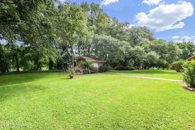 138 Cypress Dr, Opelousas, LA 70570 - view of green lawn featuring view of scattered trees and a garage