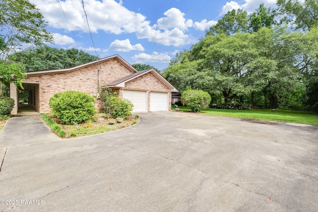138 Cypress Dr, Opelousas, LA 70570 - view of side of property with brick siding, driveway, an attached garage, and a yard