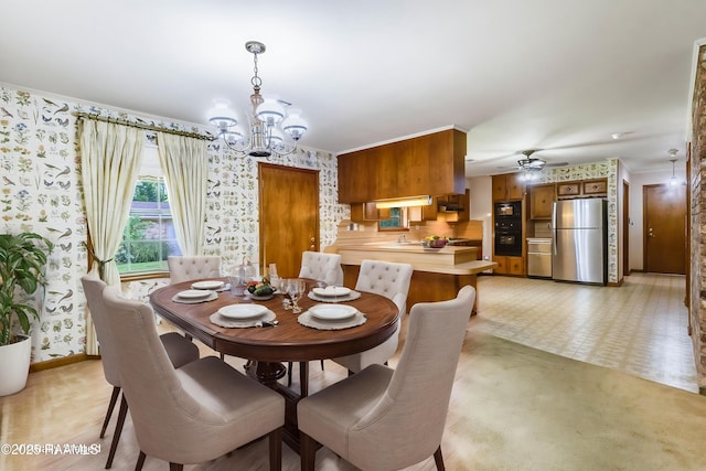 138 Cypress Dr, Opelousas, LA 70570 - dining room featuring wallpapered walls, a chandelier, ceiling fan, and baseboards